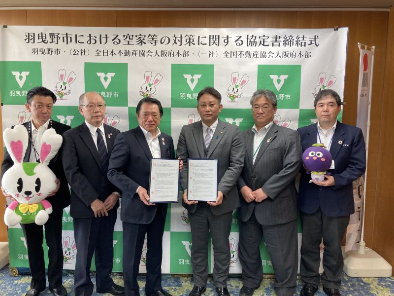 協定締結直後。左から全日大阪の田島公益事業推進副委員長、八木場同委員長、堀田本部長。羽曳野市の山入端市長、伊藤副市長、宮田都市開発部長
